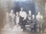 Their father is in white, and the tallest. He is second from the left, in back